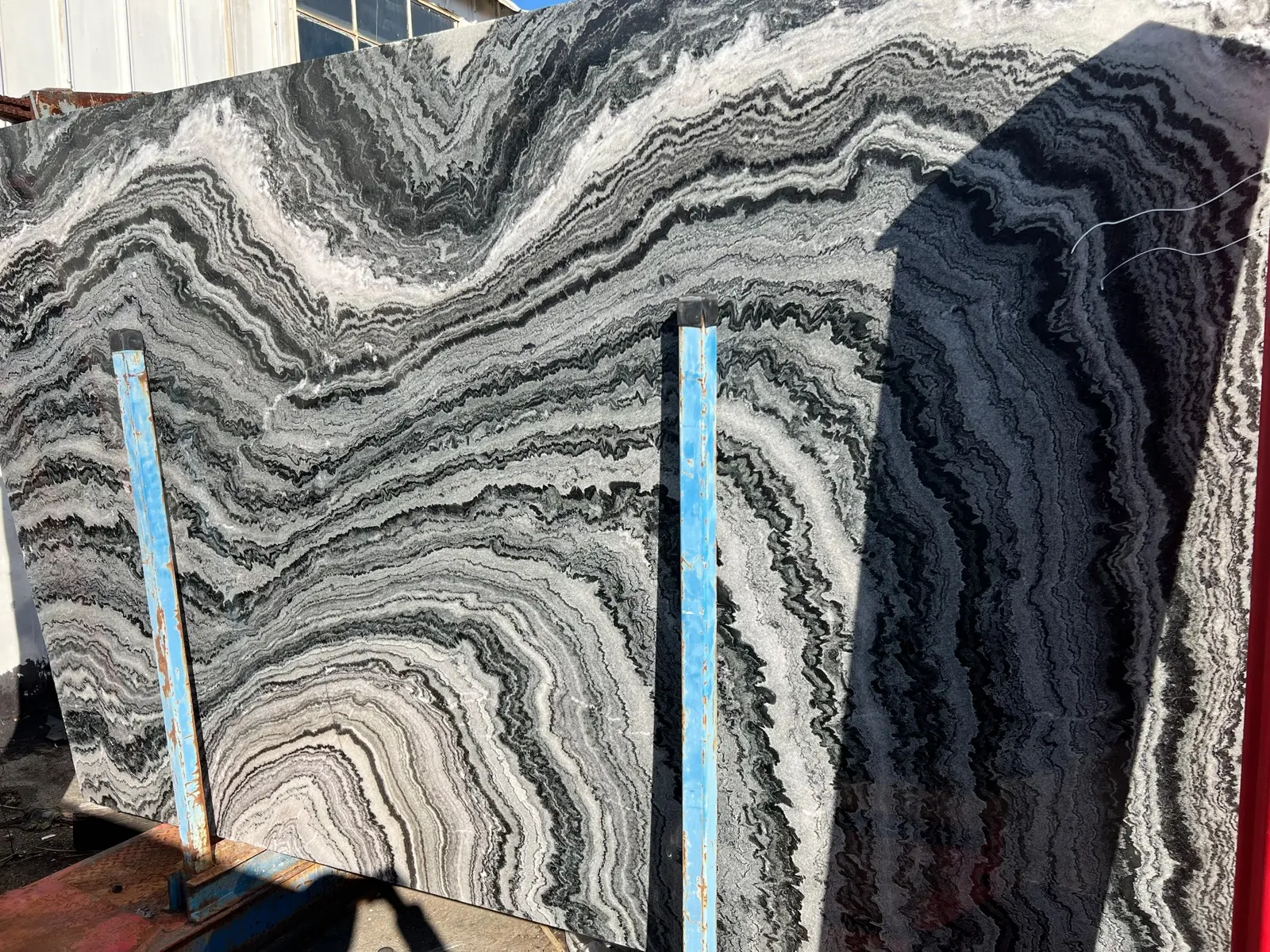 Black and white natural stone slab with bold linear movement.