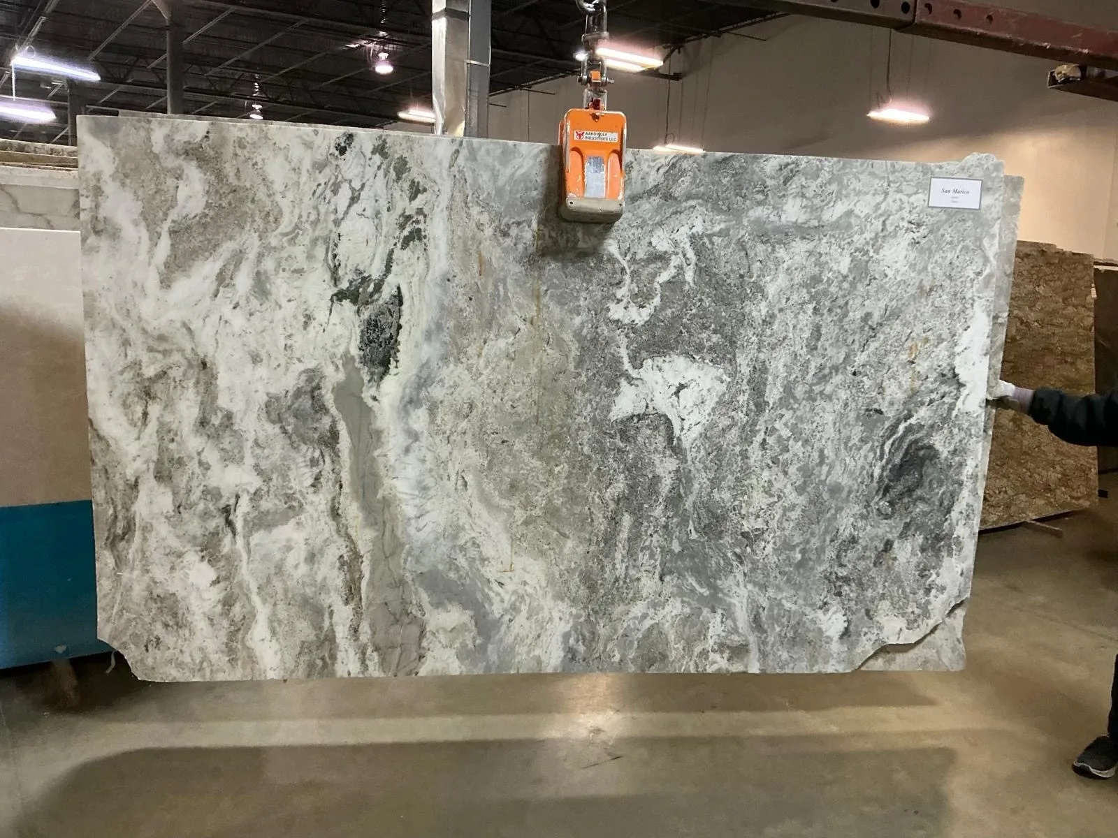 Gray and white natural stone slab with crystalline movement and layered detail.