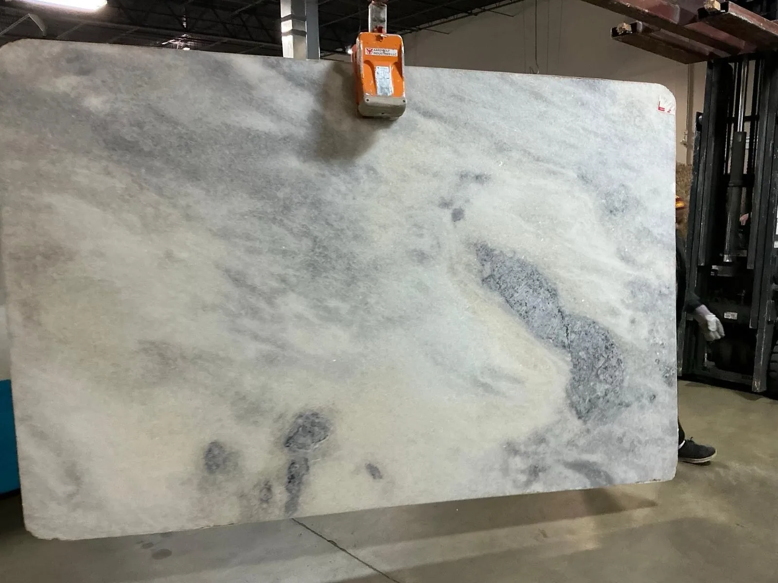 Pale gray and white natural stone slab with soft cloud-like movement.
