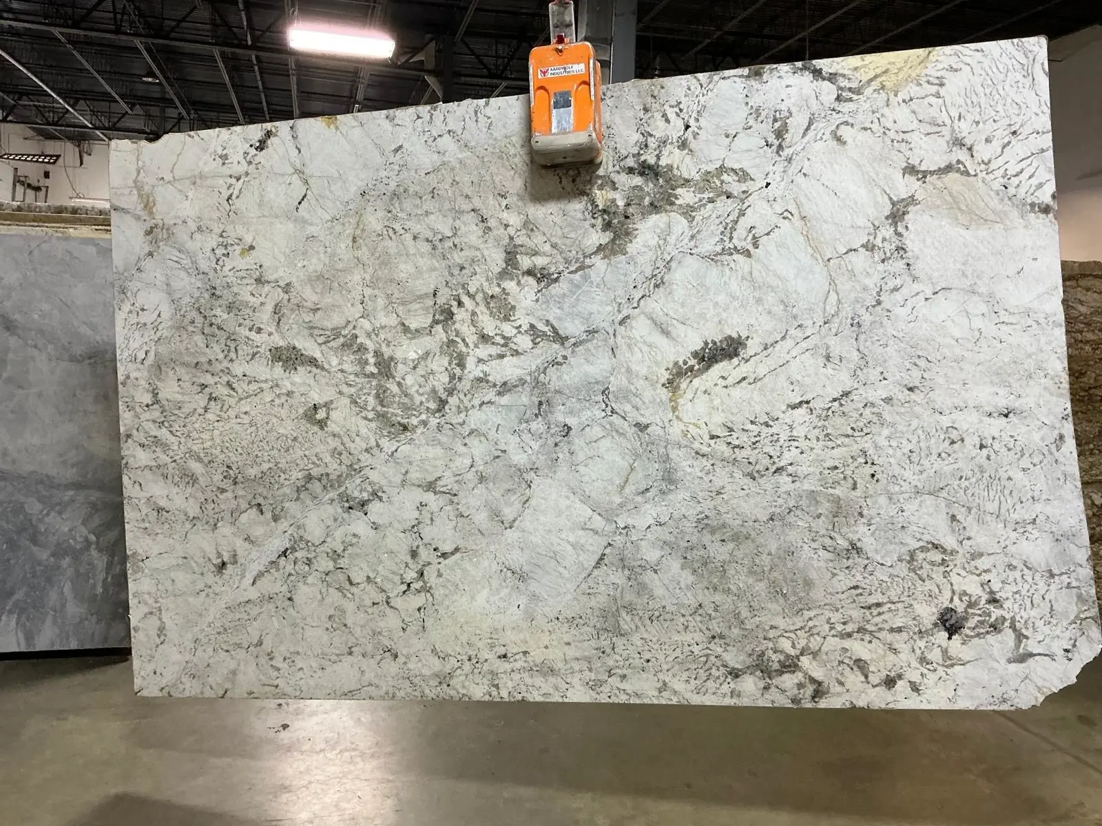 White and gray natural stone slab with soft movement for countertop inspiration.